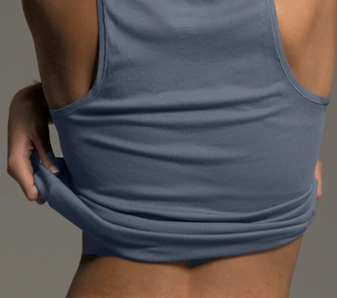 Blue tank top lifted to show the waistband